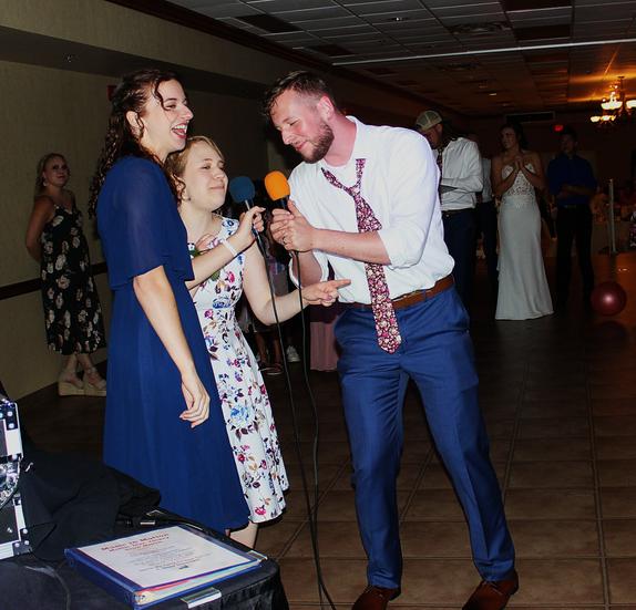 After a wonderful ceremony at Thorncrown Chapel, the groom: Luke Gibson, sings a karaoke song at his wedding reception held at the Best Western Inn of the Ozarks in Eureka Springs Arkansas.