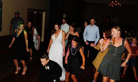 Jessica Rathke Deaver dances with her friends and family to the Cupid Shuffle at her wedding Reception being held at the Best Western Inn of the Ozarks in Eureka Springs Arkansas.