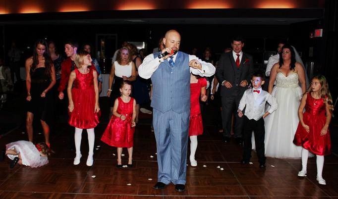 DJ Sean Hearn teaches the bride, groom and wedding party a new line dance at a reception held at the Mt Magazine Lodge in Paris, Arkansas.
